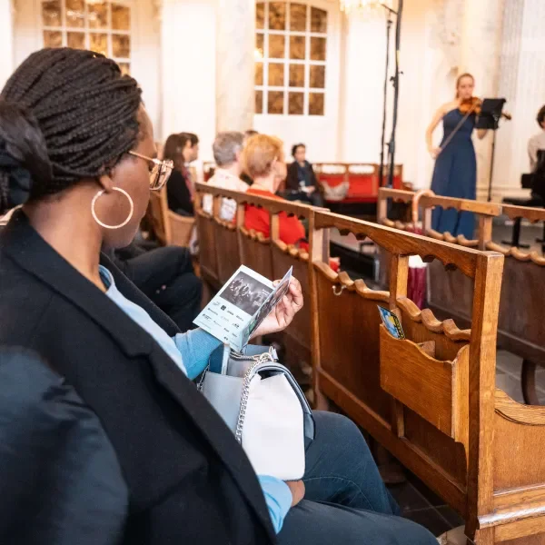 woman reading a programme booklet
